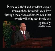 a man in a suit and tie standing at a podium with a quote on it