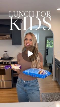 a woman is holding a blue bag in her hands and smiling at the camera with words lunch for kids on it