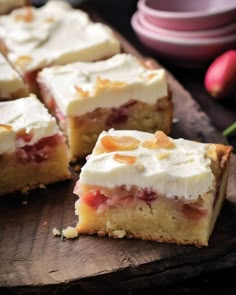 slices of cake sitting on top of a wooden cutting board