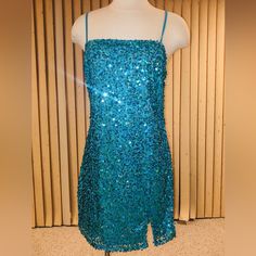 Sequin Mini Dress With Front Side Centered Front Split And Fully Lined. Side Zipper. Dress Has Stretch, But Runs Small, More Lie A Large. Bust 3640, Waist, 3236 Hips, 4044, And 34 Inch Length. Ties In The Back Adjustable Straps. A Great Party Dress For The Holidays. Turquoise Evening Dresses With Sequins, Turquoise Mini Dress For Summer Party, Blue Mini Sequin Dress For Spring, Blue Sequin Knee-length Dress, Blue Knee-length Sequin Dress, Fitted Turquoise Mini Dress, Blue Sequin Dress For Homecoming In Spring, Blue Knee-length Mini Dress With Sequins, Turquoise Summer Party Dress