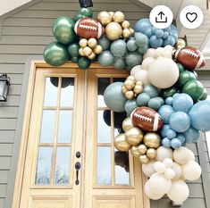 a football balloon wreath on the front door of a house with balloons attached to it