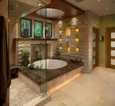 a bathroom with a large tub next to a walk - in shower and stone walls