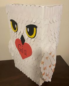 an owl made out of paper sitting on top of a table