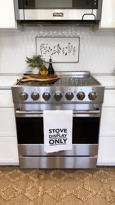 a stove top oven sitting inside of a kitchen next to a wall mounted microwave above it