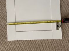 a ruler is on the floor next to a door