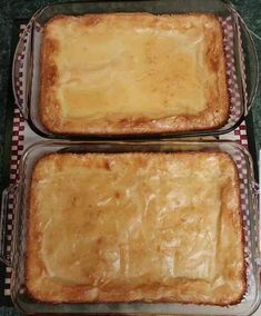 two pans filled with food sitting on top of a counter next to each other