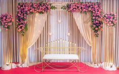 a decorated stage with flowers and candles on the side for a wedding or special event