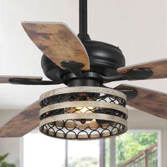 a black ceiling fan with wooden blades and a caged light fixture hanging from the ceiling