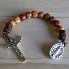 We thank you for looking at our pocket rosaries. We have over 100 unique rosaries, using different color paracords, beads and High-quality Crucifixes. We are sure you will find the perfect one for you, and you'll love it. This beautiful prayer gives Jesus and Mary praise and deserves a rosary that represents the beauty of this prayer, which you can get in your favorite color. Our rosaries are unique and all handmade with love.- Beautiful and Unique design - Loose between beads which makes going Adjustable Spiritual Rosary With Spacer Beads, Adjustable Brown Hand-strung Rosary, St Louis De Montfort, Saying The Rosary, Contemplative Prayer, Pocket Rosary, Cross Beads, Rosary Jewelry, Jesus And Mary