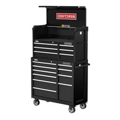 the craftsman's tool cabinet is on wheels with drawers and tools in front of it