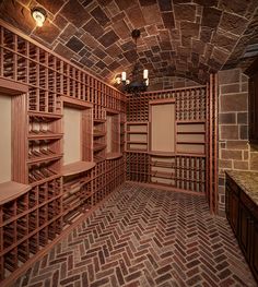 an empty wine cellar with brick walls and shelves