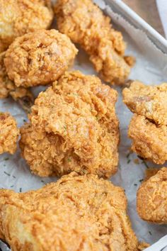 chicken nuggets are sitting in a pan on the table