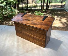 a wooden box that has the word mail written on it and some black scissors sticking out of it