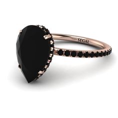 a rose gold ring with an oval black stone surrounded by smaller black stones and the word special written on it