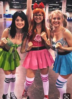 three girls dressed in costumes posing for the camera