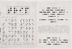 an open book with black and white dots on it's pages, which are lined up in rows