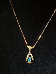 "This Blue Topaz Lavaliere was made in C-1910-1920 which is the time that they made more Lavaliere. It is in a tear drop shaped with open metal work with each side adorn with Gold & Rose Gold ornate design. At the bottom center is a prong set Blue Topaz also shaped in a tear drop. Above is an ornate winged bar with 2 small rings that have the chain attached. The chain is a gold link chain with a hallmark on 1 ring that reads \"1/20th 12K GF\". This necklace was purchased at an Estate Sale an Formal Blue Necklace With Rose Cut Diamonds, Exquisite Gold Necklace For Collectors, Victorian Gold Teardrop Necklace, Heirloom Pear-shaped Gold Jewelry, Victorian Pear-shaped Gold Jewelry, Antique Gold Pear-shaped Jewelry, Gold Hallmarked Pear-shaped Necklace, Antique Pear-shaped Gold Jewelry, Gold Pear-shaped Hallmarked Necklace