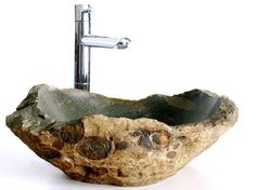 a sink made out of rocks with a faucet