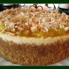 a close up of a cake with toppings on it sitting on a white plate