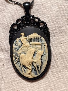 Greco-Roman goddess on a chariot cameo, on a black beaded chain Black Cameo Medallion Necklace, Smoky Quartz Earrings, Greco Roman, Rabbit Pendant, Roman Goddess, Athena Goddess, Cameo Necklace, Quartz Earrings, Black Beads