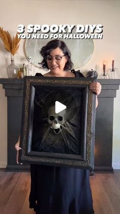 a woman holding up a framed photo with a skull in the middle and text 3 spooky diys you need for halloween