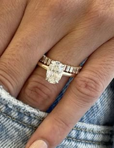 a close up of a person's hand with a ring on it