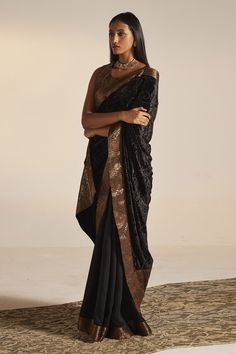 Black saree in silk velvet fabric base and floral banarasi woven border.
Component: 1
Pattern: Woven
Type Of Work: Floral
Fabric: Silk Velvet, Banarasi
Color: Black
Other Details: 
Approximate Product Weight (in kg): 1
Note:
Blouse worn by the model is not for sale
Since all our products are sustainable and touched by human hands for weaving, block printing and embroidery; there might be a slight imperfections that make them unique and individual.
Occasion: Sangeet - Aza Fashions Velvet Saree, Floral Saree, Silk Velvet Fabric, Saree For Women, Black Saree, Human Hands, Fashion App, Block Printing, Banarasi Sarees