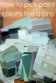 a pile of paint samples sitting on top of a wooden table with text overlay that reads how to pick paint colors like a pro