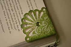 an open book with a green and white design on it