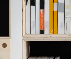 a bookshelf filled with lots of different colored books