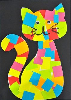 a cat made out of colored paper on a black background