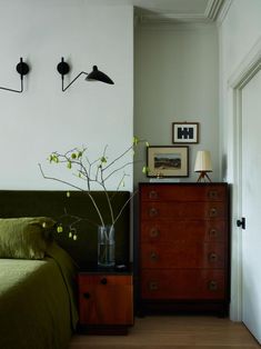 a bed room with a neatly made bed and a dresser