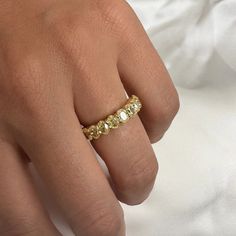 a woman's hand with a yellow diamond ring on it