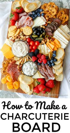 a wooden board with cheese, crackers and fruit on it that says how to make a charcuterie board