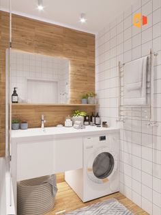 a washer and dryer in a bathroom with wood paneling on the walls