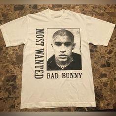 Bad Bunny Most Wanted Tour Official Merch Shirt In Size Small. Shirt Was Purchased 5/4/23 At American Airlines In Dallas, Tx. New Never Been Worn. Ready To Ship. Comes From A Smoke-Free Home. Cross Posted Listing. Bad Bunny Shirts, Bad Bunny Merch, Merch Shirt, Bunny T Shirt, Bunny Shirt, Most Wanted, American Airlines, Bad Bunny, Dallas Tx