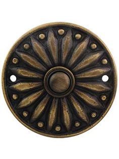 an old fashioned door knob with holes in the middle and a circular design on it