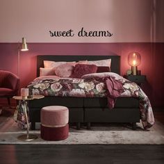 a bedroom with pink walls and a bed in the middle, along with a wall sticker that says sweet dreams