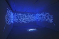 an art installation with blue lights in a room