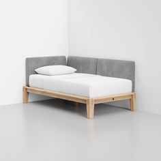 a bed that is made out of wood and white sheets