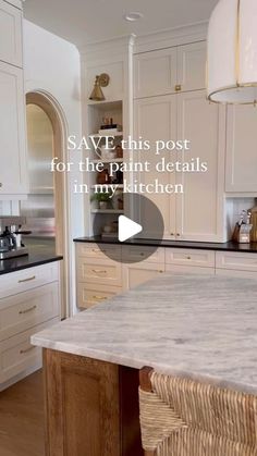 a large kitchen with white cabinets and marble counter tops, an island in the middle