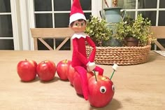 an elf is sitting on top of apples