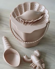 a set of utensils sitting on top of a wooden table next to a bowl and spoon