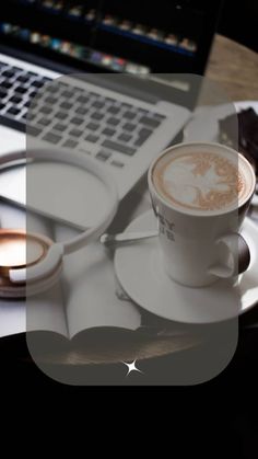 a cup of coffee sitting on top of a saucer next to a laptop computer