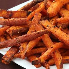 a white plate topped with french fries covered in seasoning