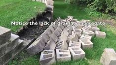 a pile of cement blocks sitting in the grass