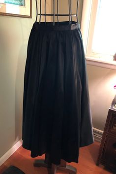 I am offering a beautiful 1950s black matte satin skirt. The skirt falls gracefully from its natural waistline. It is gathered. It is ankle length. It would be perfect as a recital skirt or for formal wear. It has a hook and snap closure. Measurements on request. Formal Pleated Satin Maxi Skirt, Formal Satin Maxi Skirt Pleated, Formal Full-length Satin Skirt, Formal Satin Maxi Skirt With Pleats, Formal Full Length Satin Skirt, Formal Solid Pleated Maxi Skirt, Formal Solid Color Pleated Maxi Skirt, Elegant Formal Satin Pleated Skirt, Evening Satin Full Skirt Bottoms