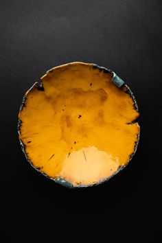 a yellow plate sitting on top of a black table