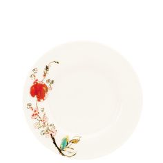 a white plate with red flowers and leaves on the rim, against a white background