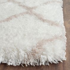 a white rug on a wooden floor